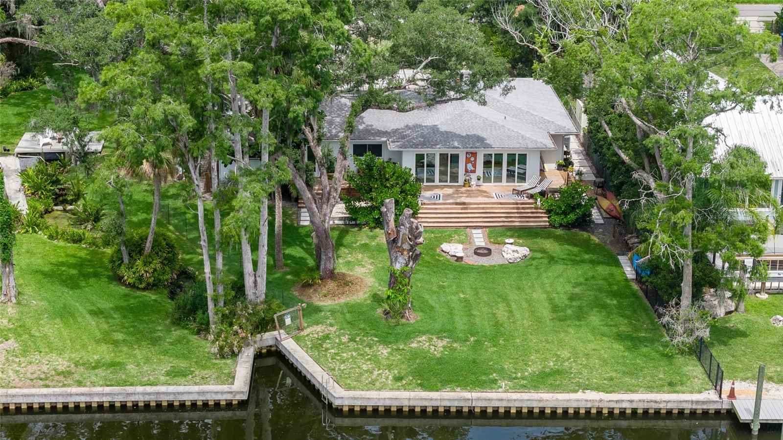 140 feet of engineered sea wall, .65 of an acre of picturesque lawns, a manicured spring, multiple fruit trees and palm trees