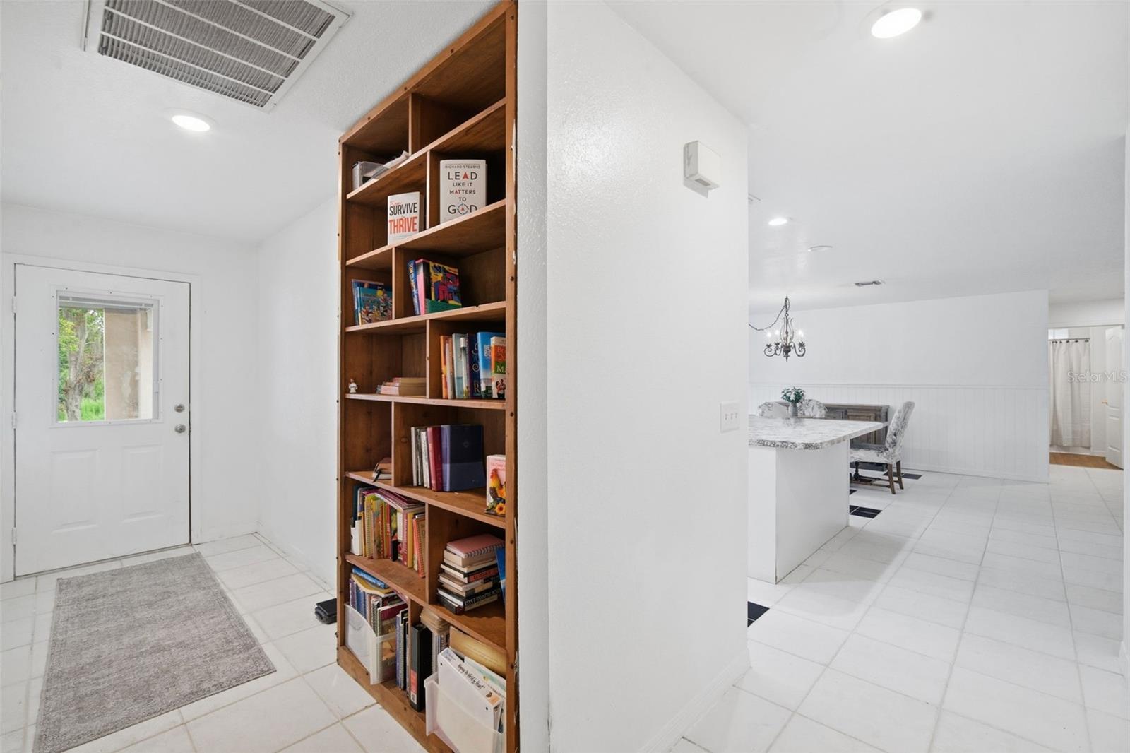 Leaving Master Suite. Kitchen on right. To the left is Laundry Room. Door is Rear entrance under carport.
