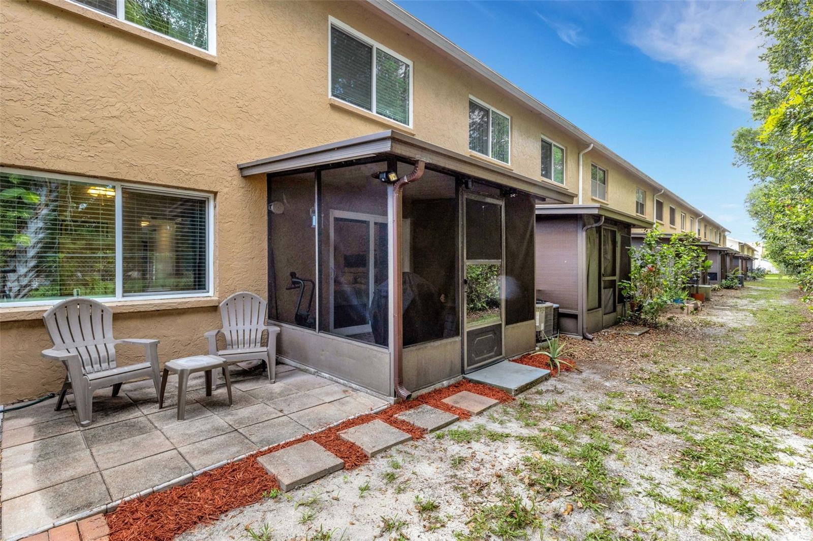 Back of Unit With Screened Porch Off Primary Bedroom and Open Sitting Area
