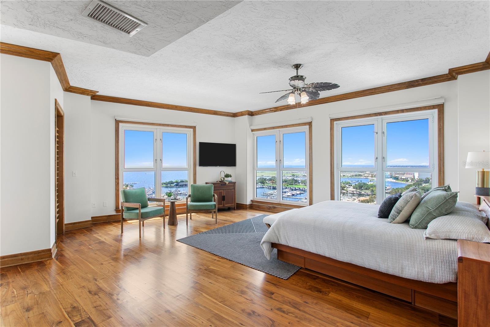 Primary bedroom — wrap around windows, bay views