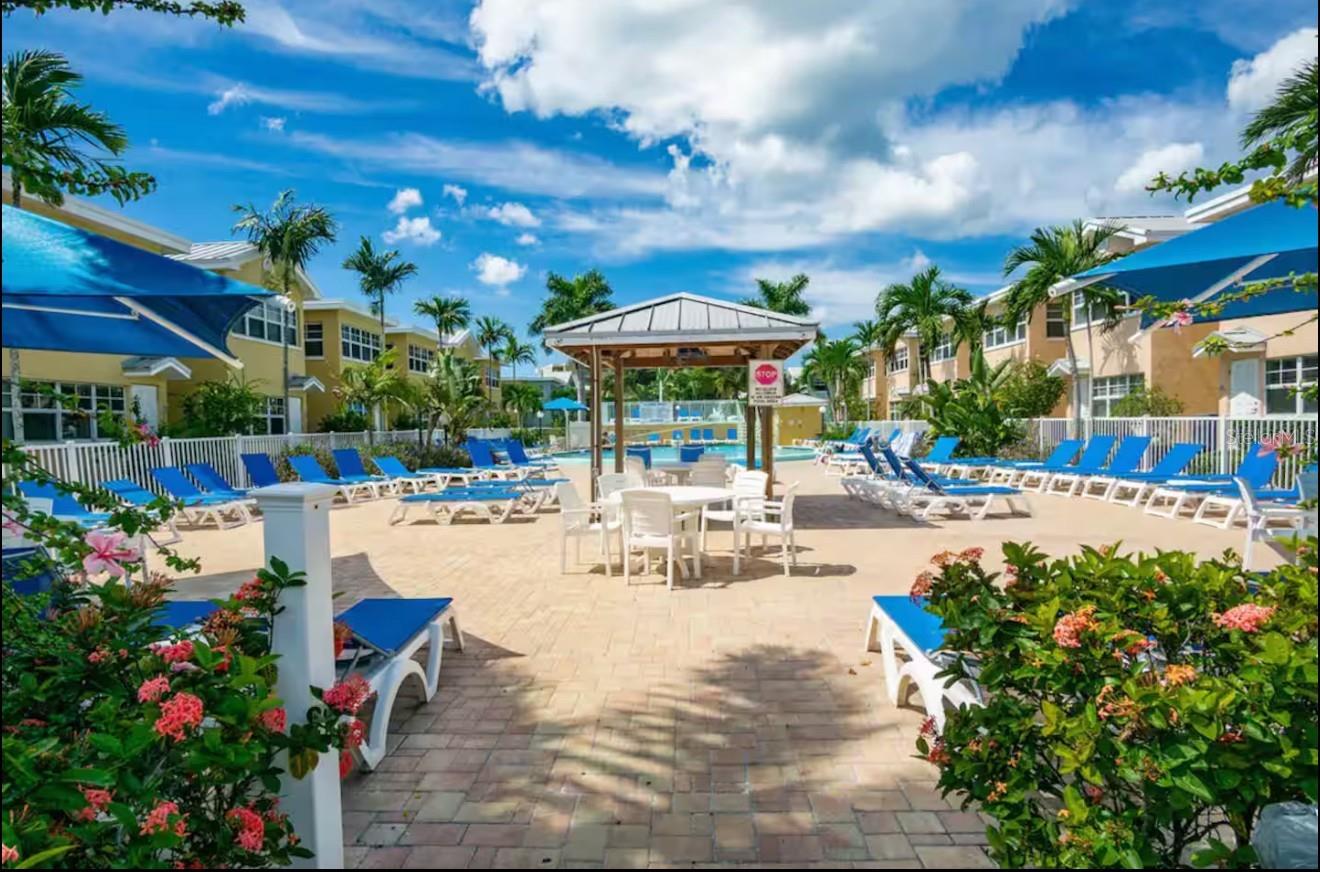 Pool area with lounge chairs and tables