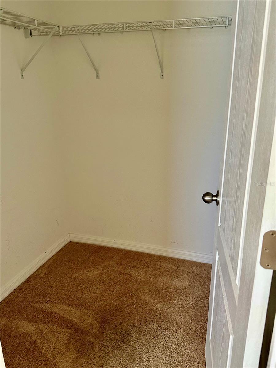 Primary bedroom walk in closet.
