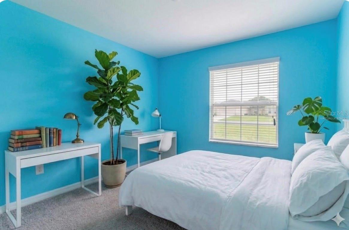 Decor virtually staged. Bedroom at front left of home.