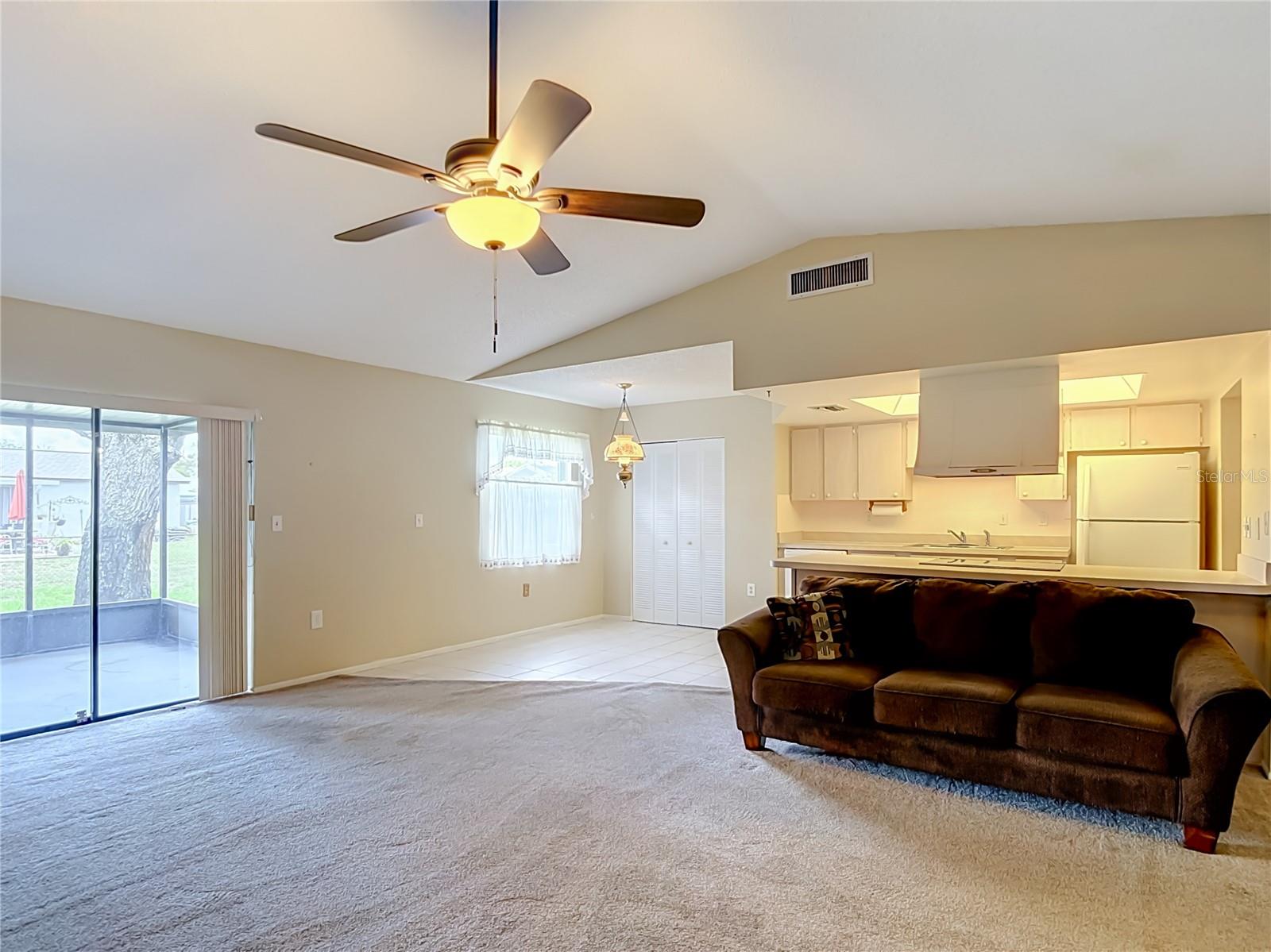 View from wood burning fireplace into eat in kitchen area and out to the screened lanai