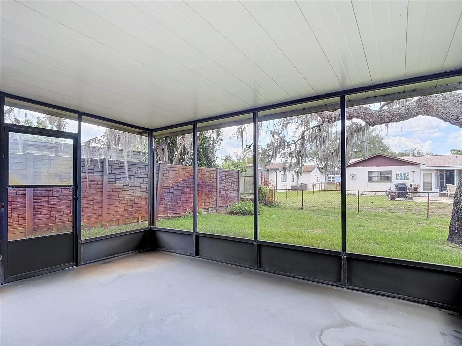 Screened lanai; yard is partially fenced
