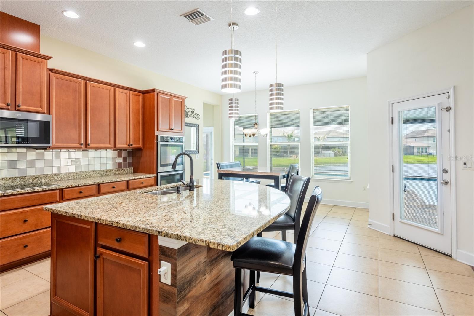 The door leads to the covered lanai and pool.