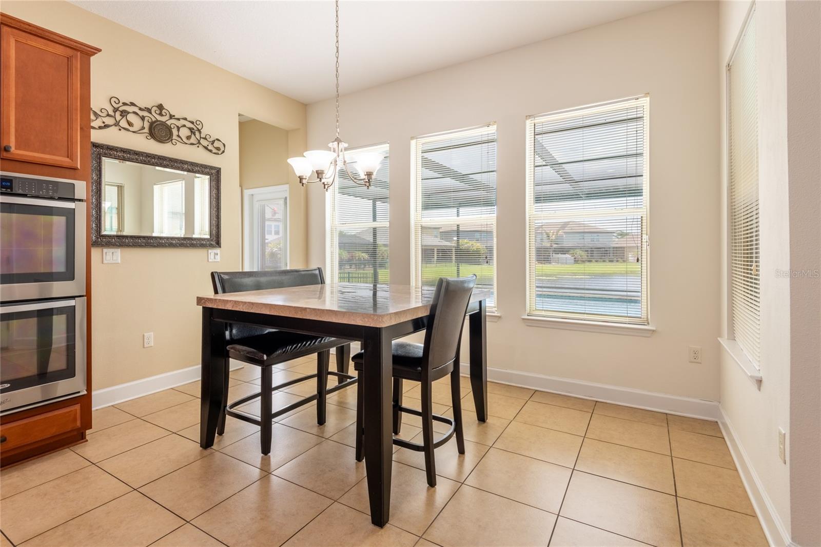 Dining area with a door that leads to the pool bath.
