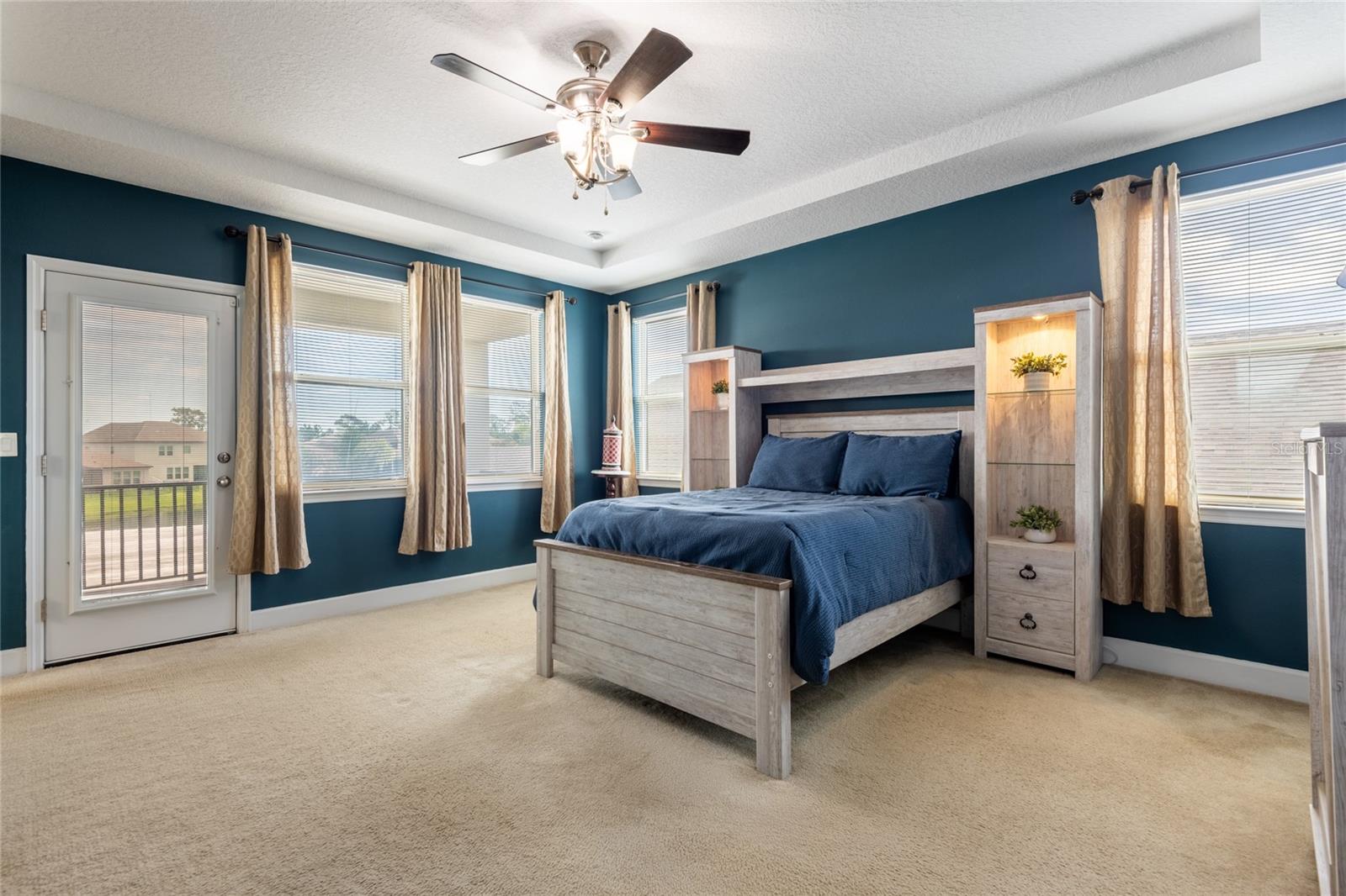 Spacious Primary Suite and the door leads to a balcony.