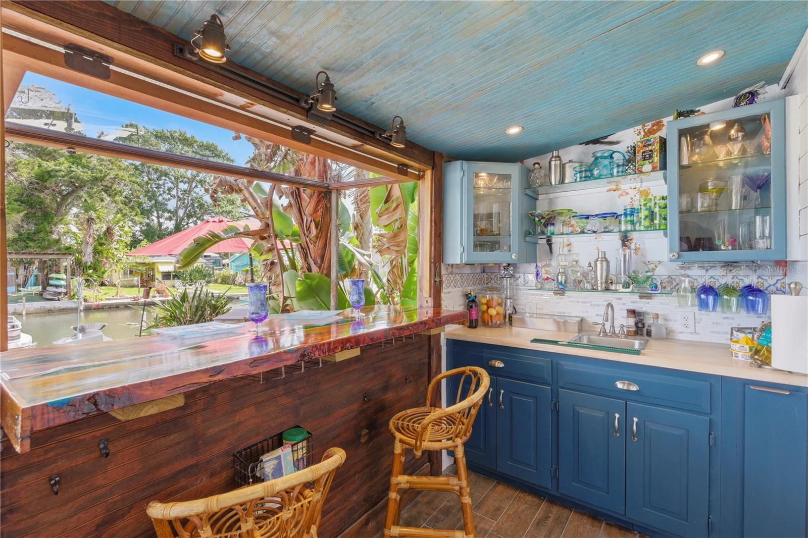 Custom Bar - exellent for entertaining - access to the outdoor open Patio, fire pit, Cabana and private EZDock on canal.