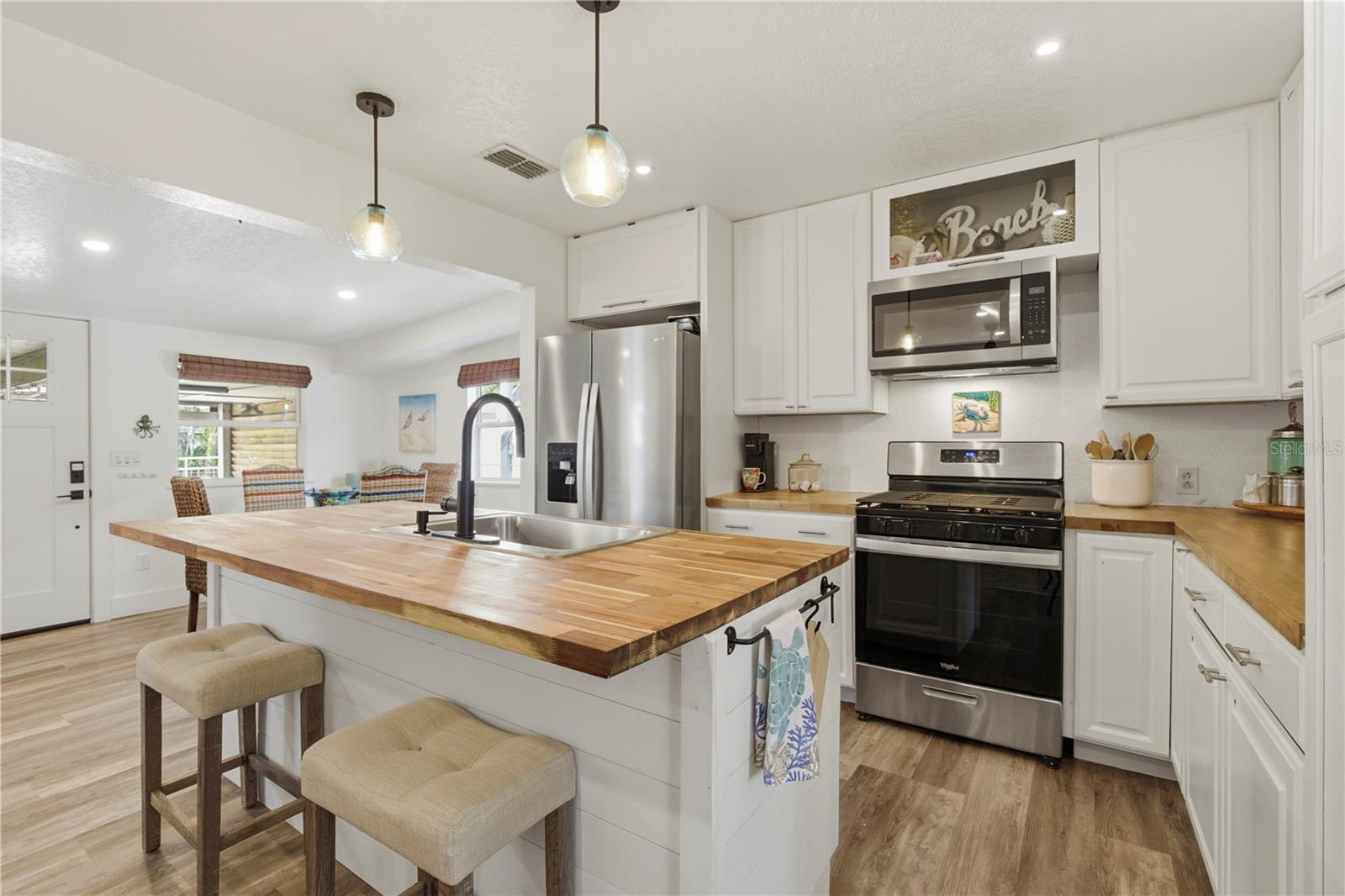 Kitchen - Custom built in kitchen Island Butcher block - with sink, all stainless steel appliances.
