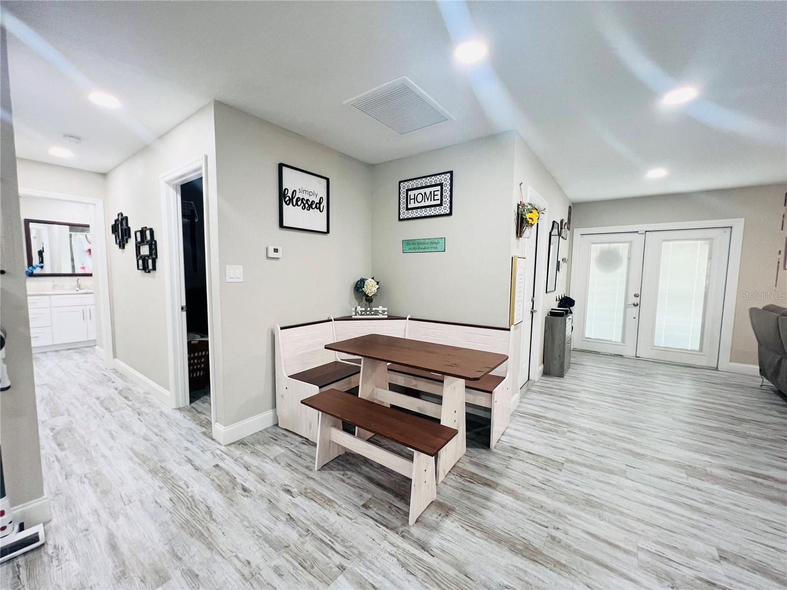 VIEW OF DINING AREA, HALL, AND ENTRANCE FROM KITHEN