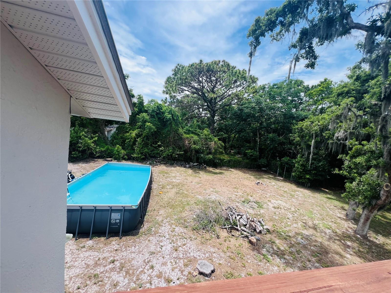 VIEW OF POOL AND YARD FROM UPPER DECK