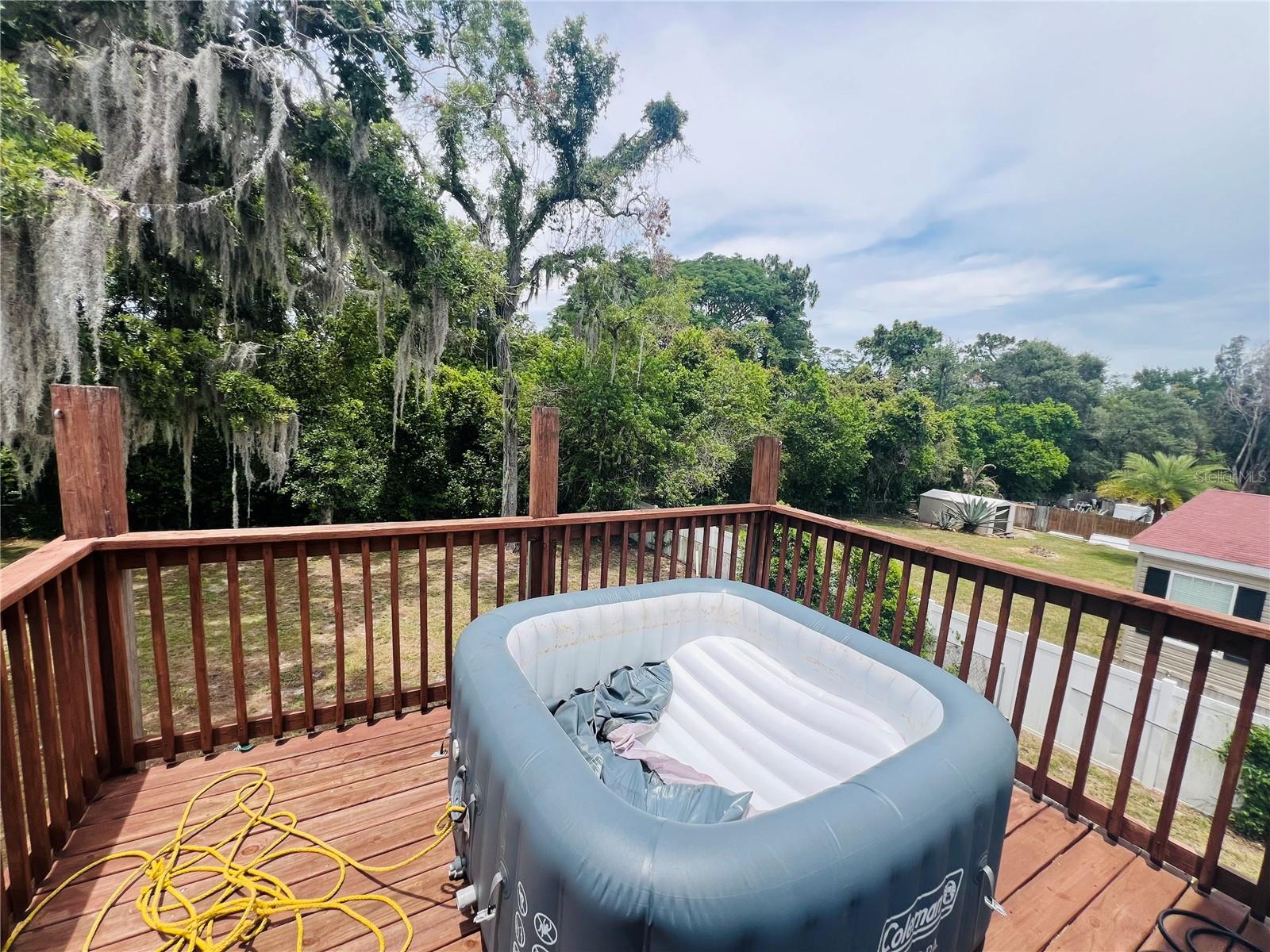 UPPER DECK WITH HOT TUB AND VIEW OF BACK YARD OFF UPSTAIRS BONUS ROOM