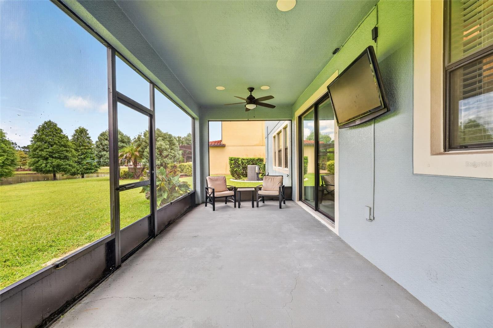 Covered and Screened Lanai with Double Ceiling Fans, Pre-Wired for Speakers and T.V. Large Screen Panels for Gorgeous View of Peaceful Natural Landscape.