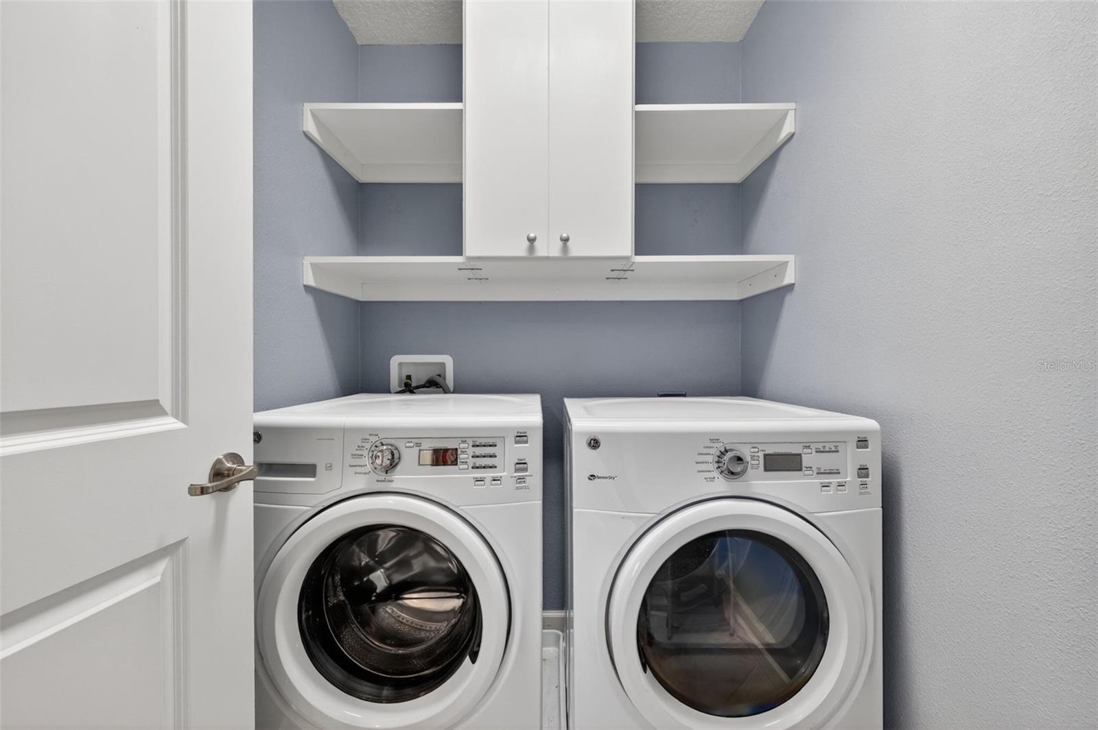 Upstairs Inside Laundry Room with Custom Cabinet, Shelving, and GE Washer & Dryer