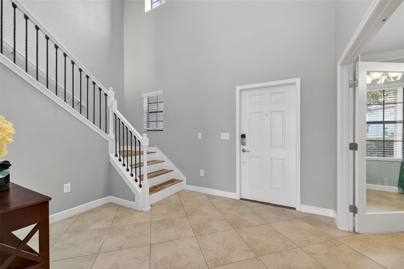 Foyer with View of Entry, Flex Room, and Staircase
