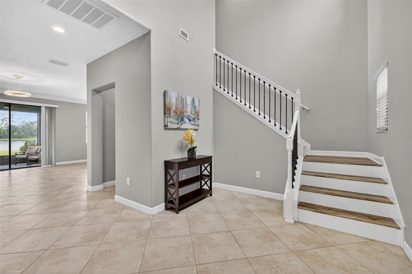 Foyer with View of Entry, Flex Room, and Staircase
