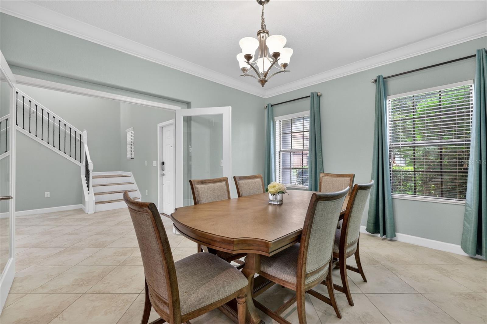 Flex Room with Double Door Glass Entry, Crown Molding and Windows to the Front of the Home.