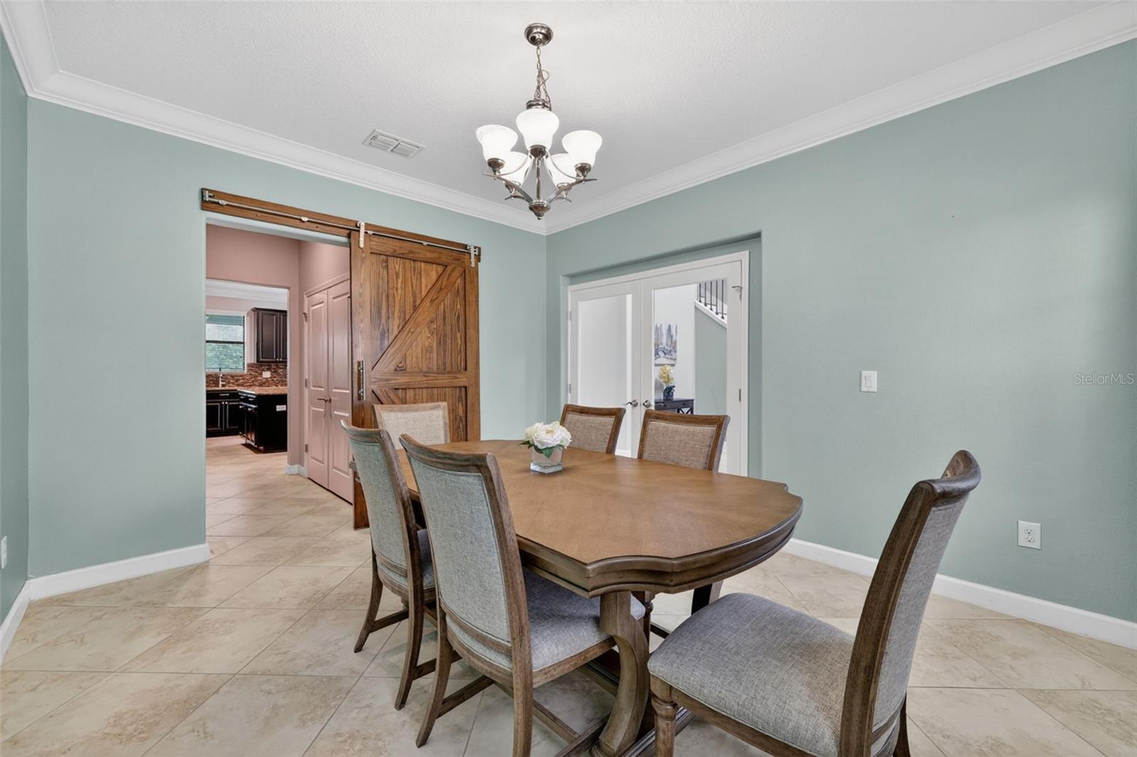 Flex Room with Crown Molding, Chandelier, and Barn Door Entry to Butler's Pantry