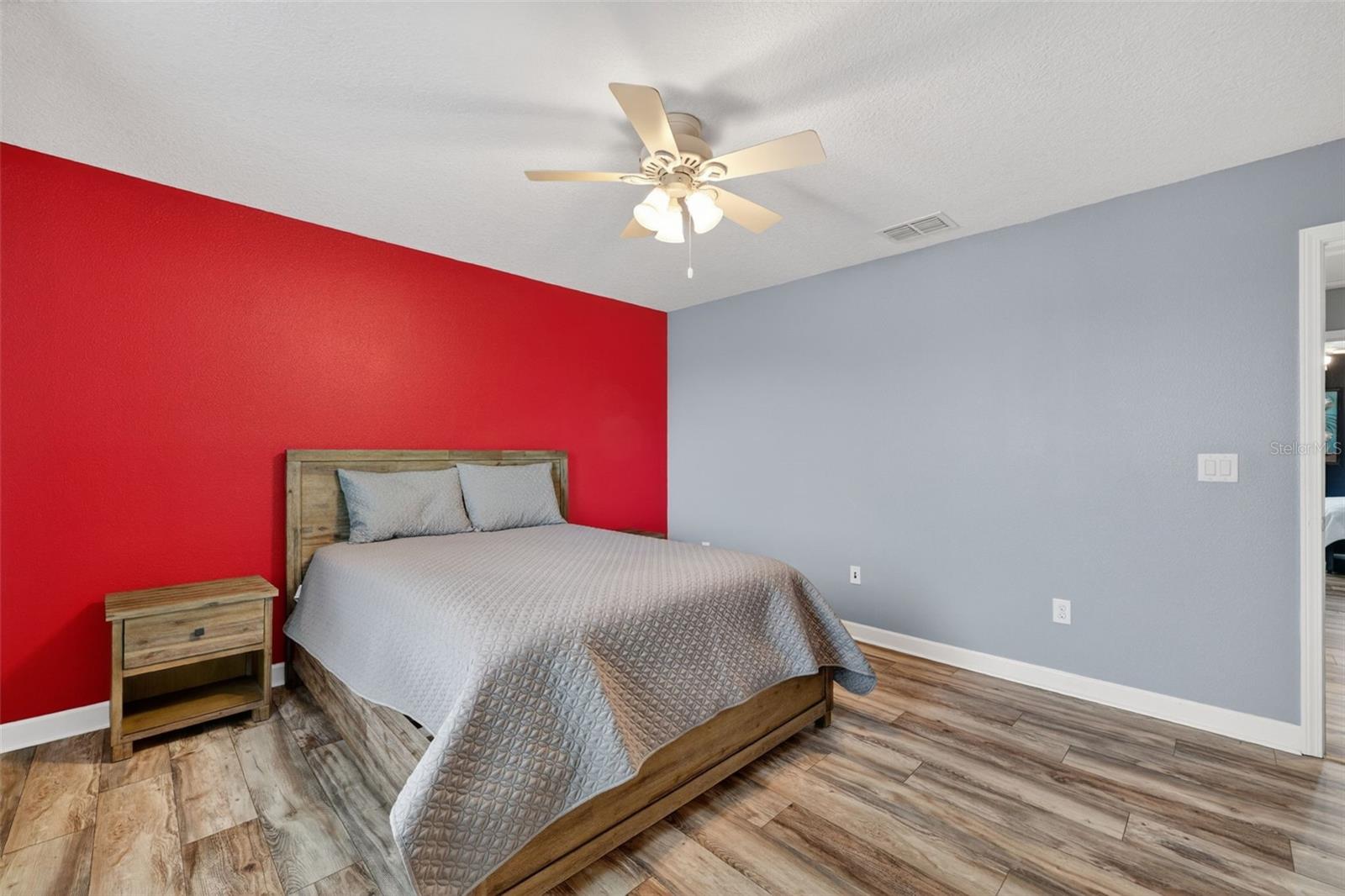 Bedroom #4 with LVP Flooring, Ceiling Fan, Built-In Closet, Accent Wall and Window Overlooing the Pond and View of Waterleaf Community!