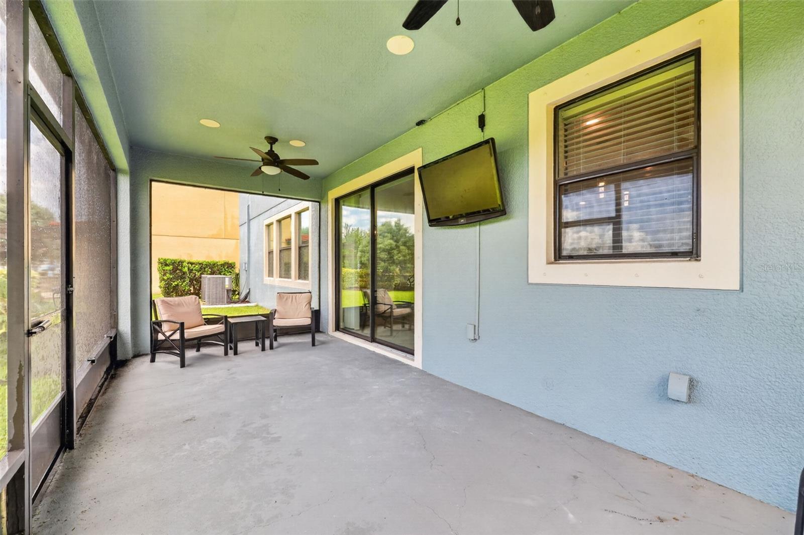 Covered and Screened Lanai with Double Ceiling Fans, Pre-Wired for Speakers and T.V. Large Screen Panels for Gorgeous View of Peaceful Natural Landscape.