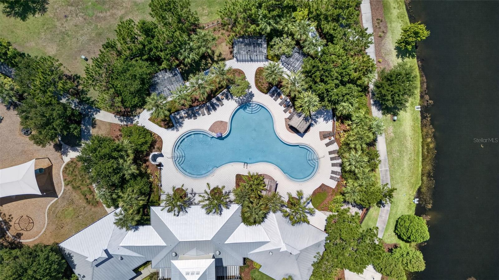 Aerial View of Amenities with Clubhouse, Resort Style Pool, Playground/Park, Sports Court, Dog Park, Walking Trails and Water View in Waterleaf Community!