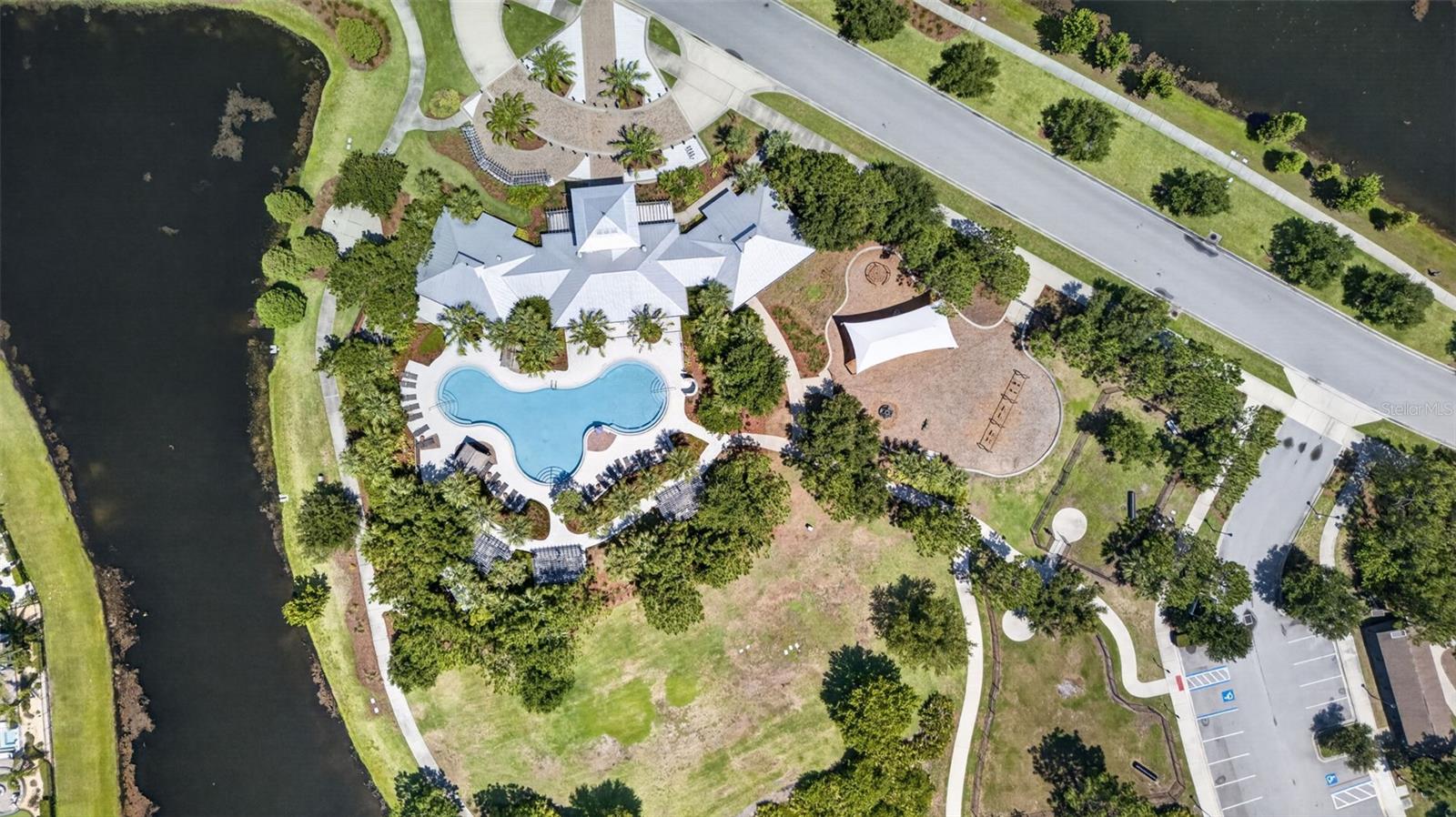 Aerial View of Amenities with Clubhouse, Resort Style Pool, Playground/Park, Sports Court, Dog Park, Walking Trails and Water View in Waterleaf Community!