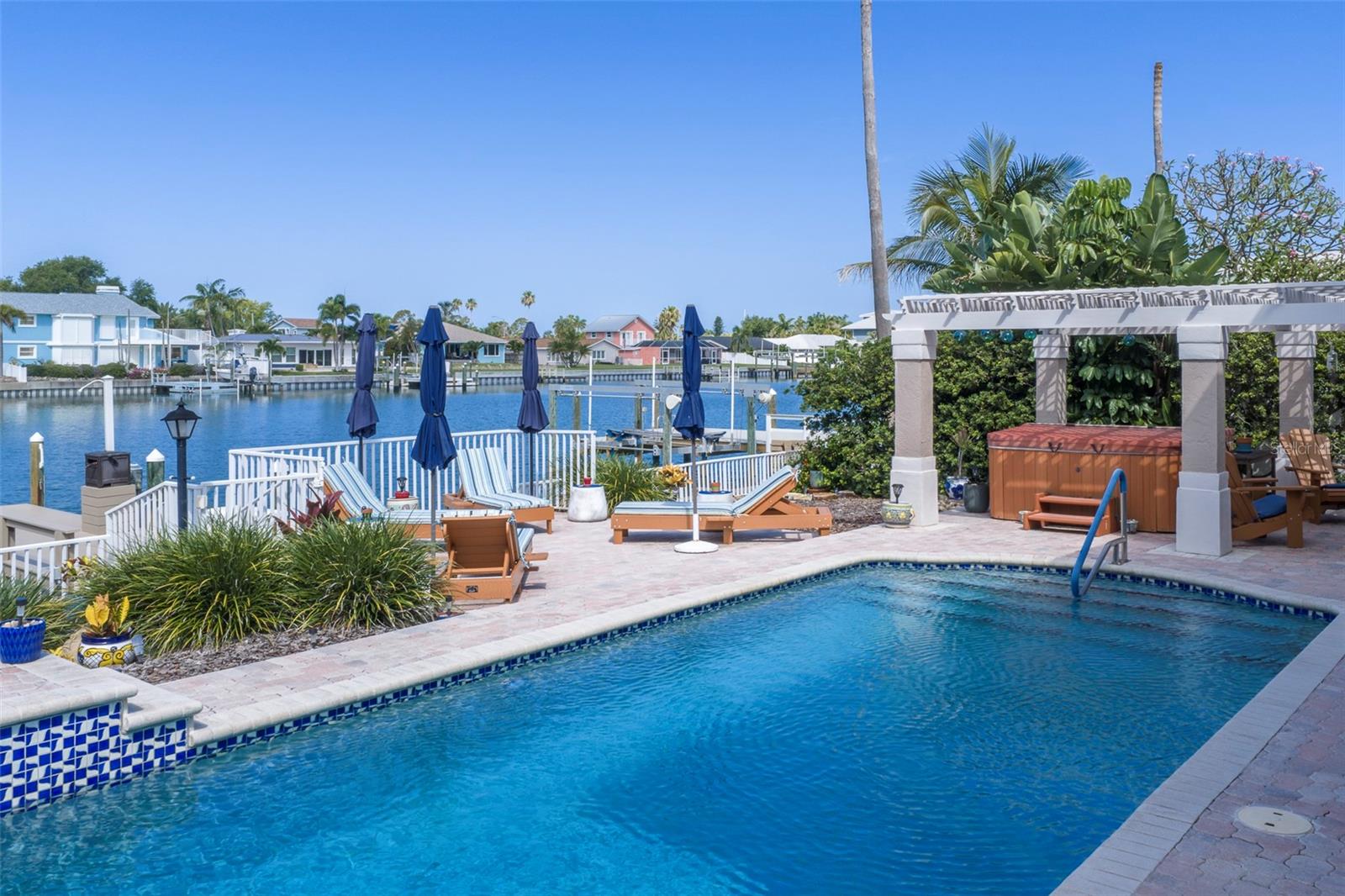 Sparkling saltwater heated pool and hot tub beneath elegant pergola