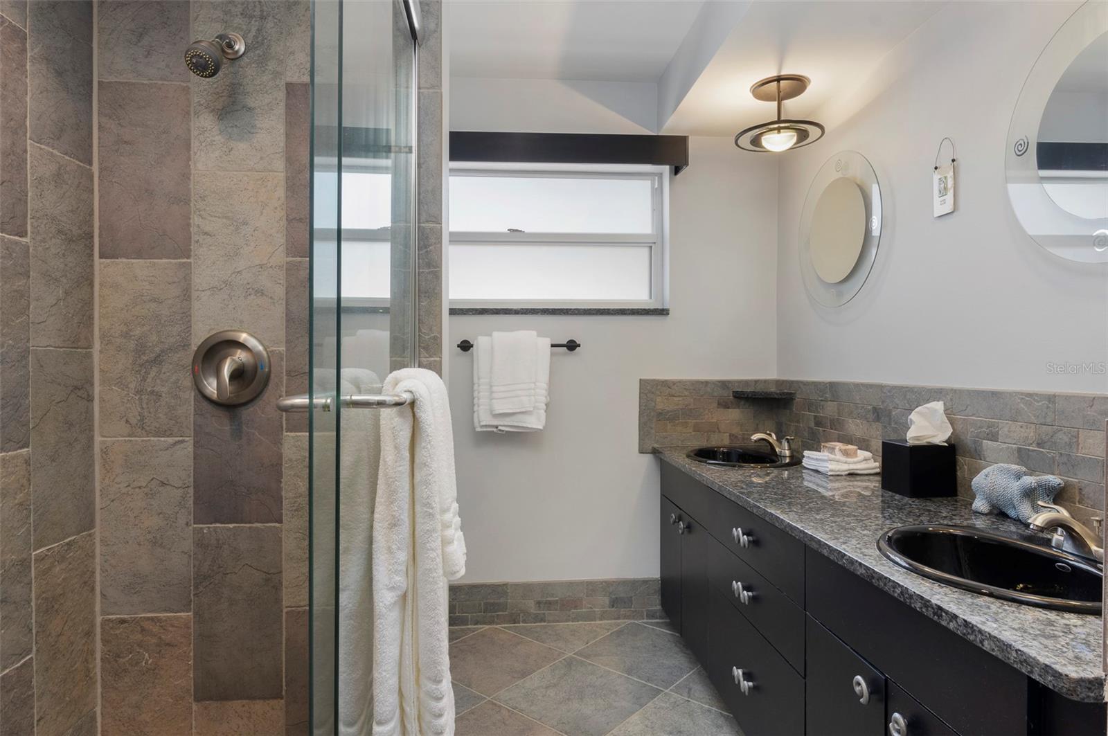 Full bath with walk-in shower services both guest bedrooms