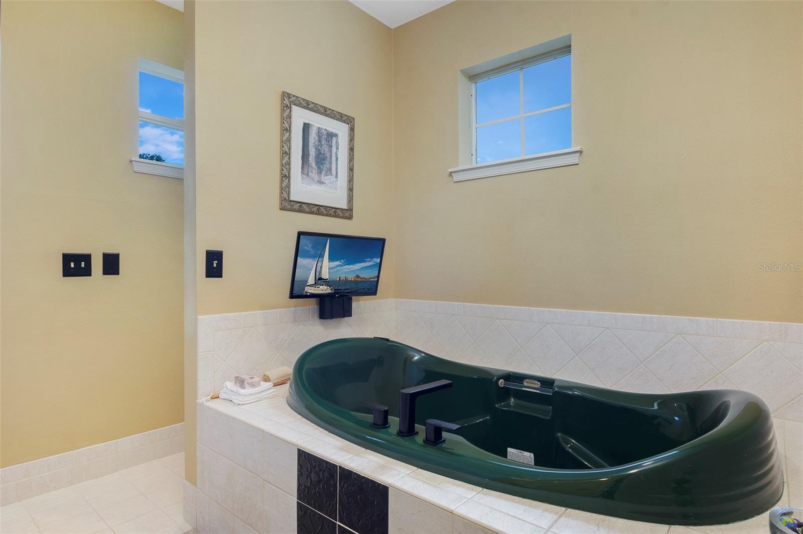 Jacuzzi bath tub is integral part of master bath