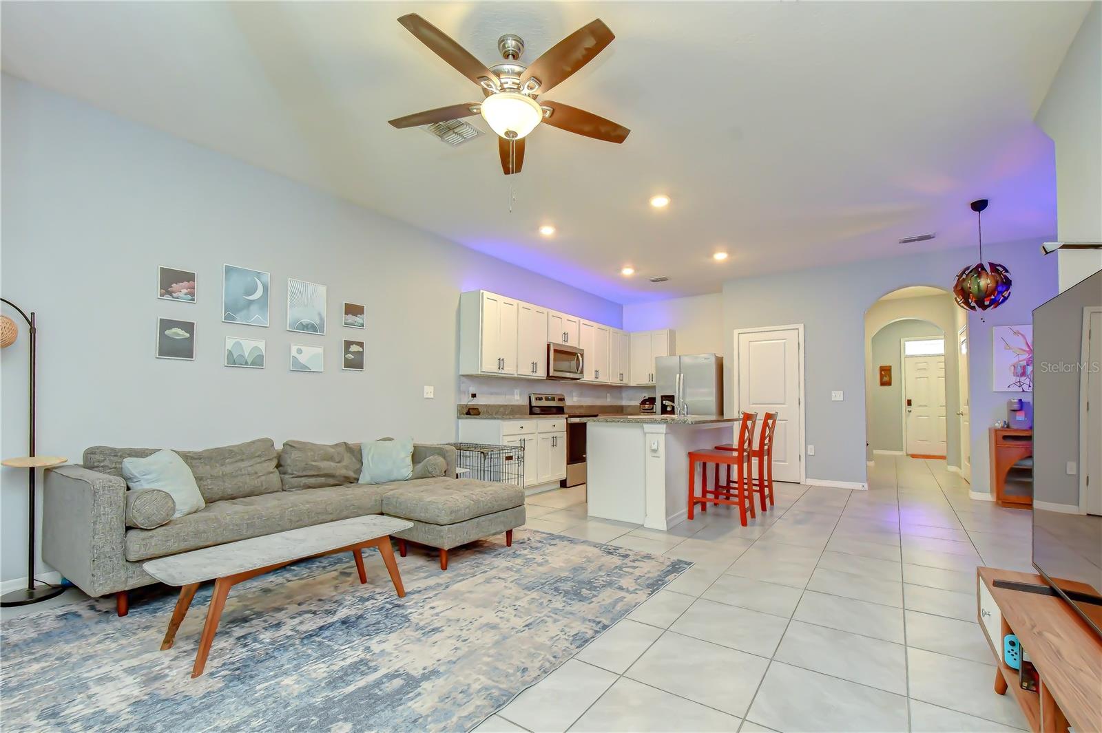Wide open sightlines from the kitchen looking out over the entire family room layout.