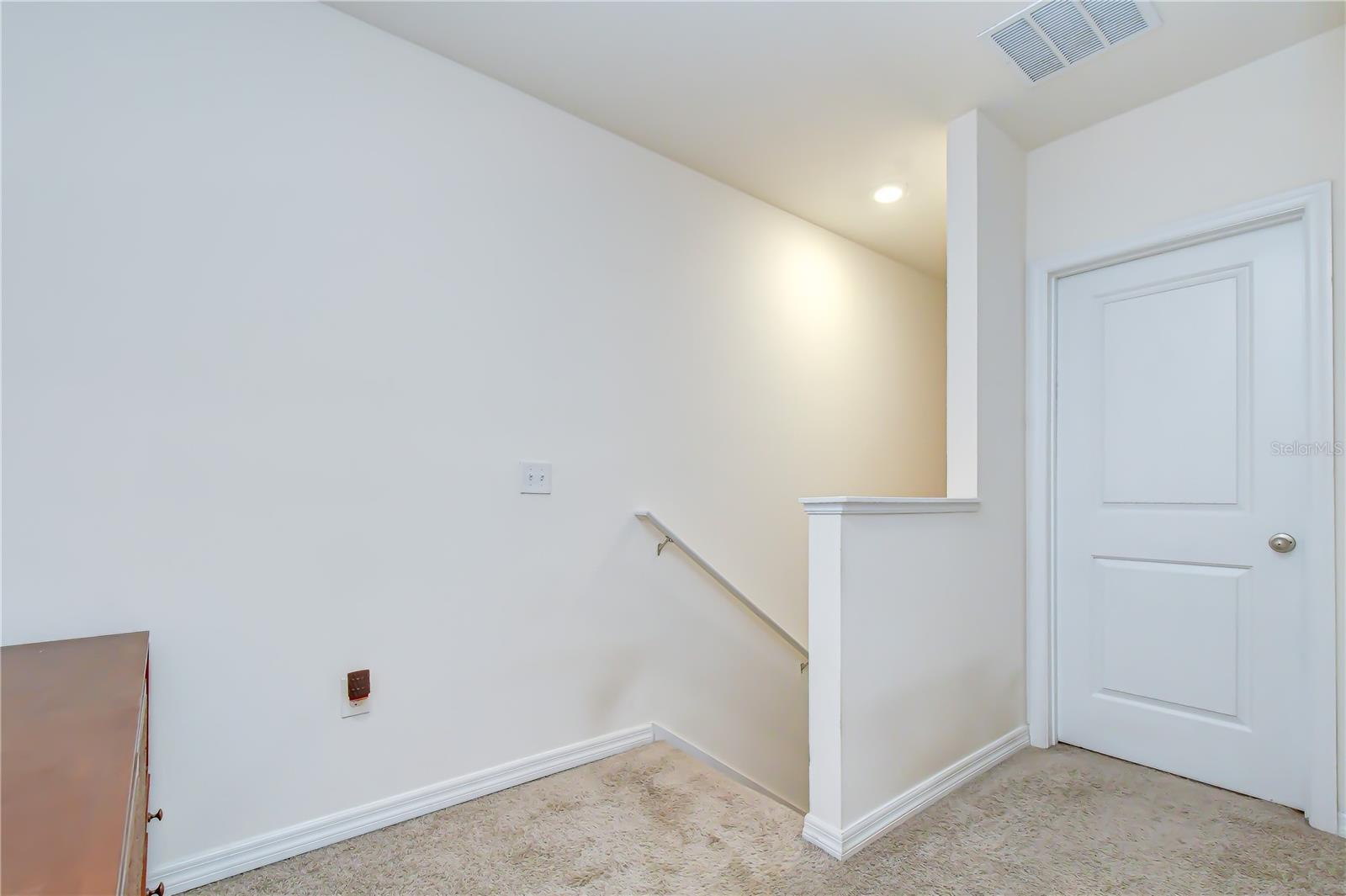 Thoughtful layout with a central staircase leading up to the private bedroom quarters.
