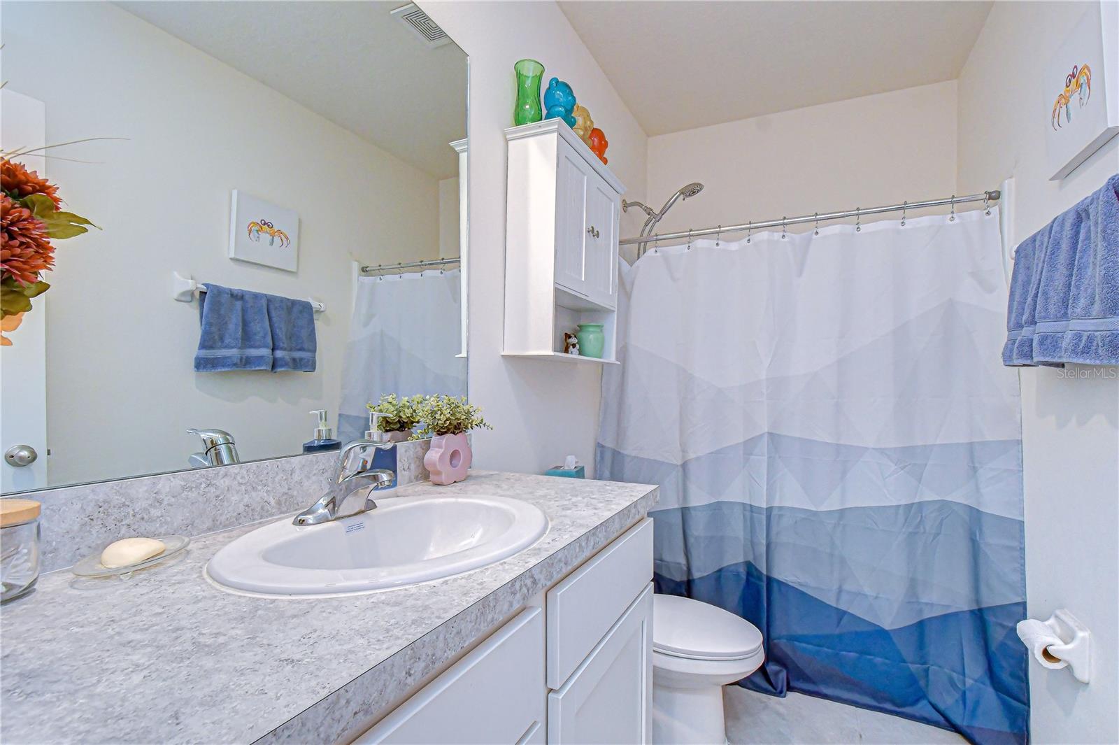 Full upstairs hallway bathroom featuring a tub/shower combo serving the secondary bedrooms.