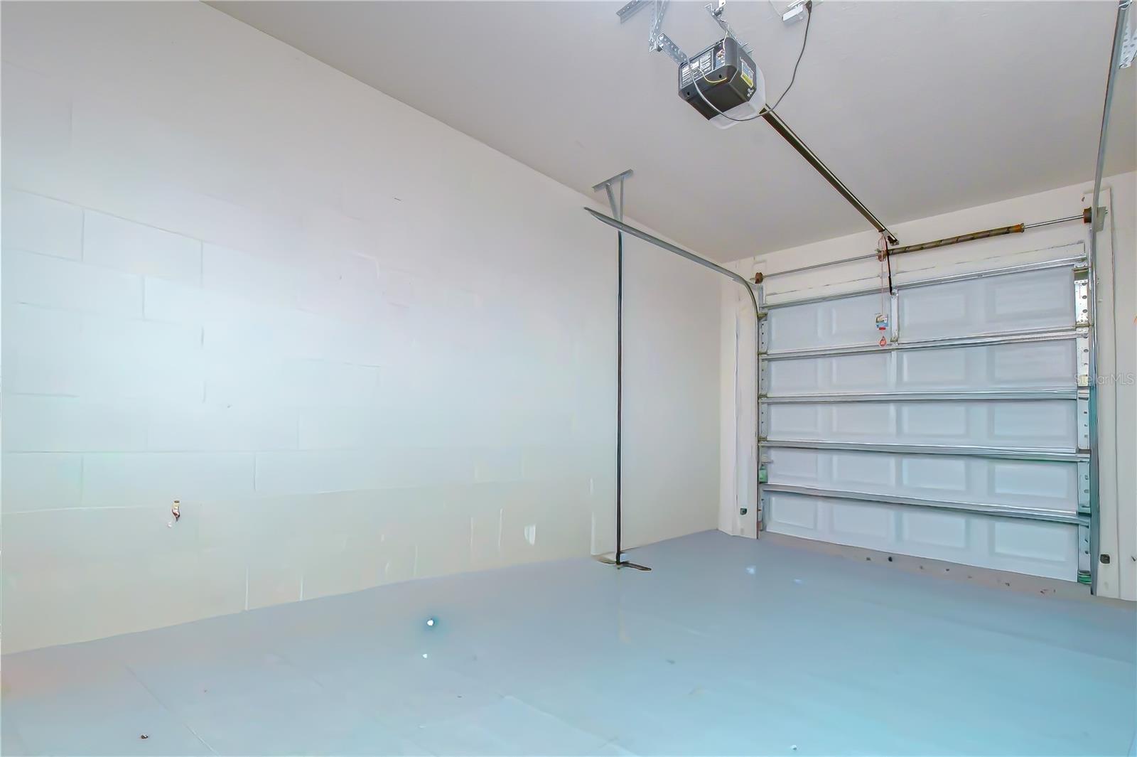 Convenient paved driveway leading to the attached one-car garage.