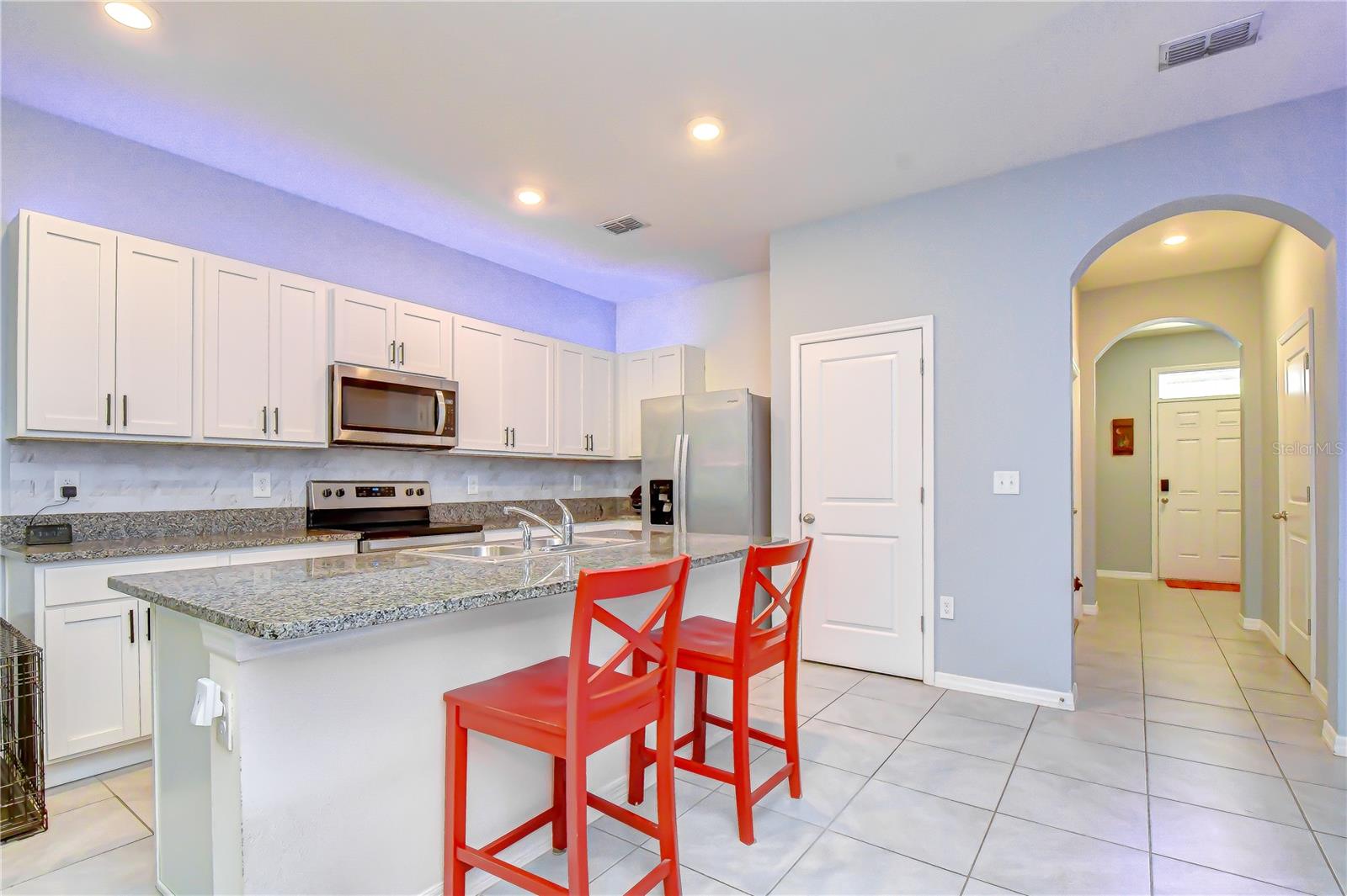 Spacious center island offering convenient breakfast bar seating for casual meals.