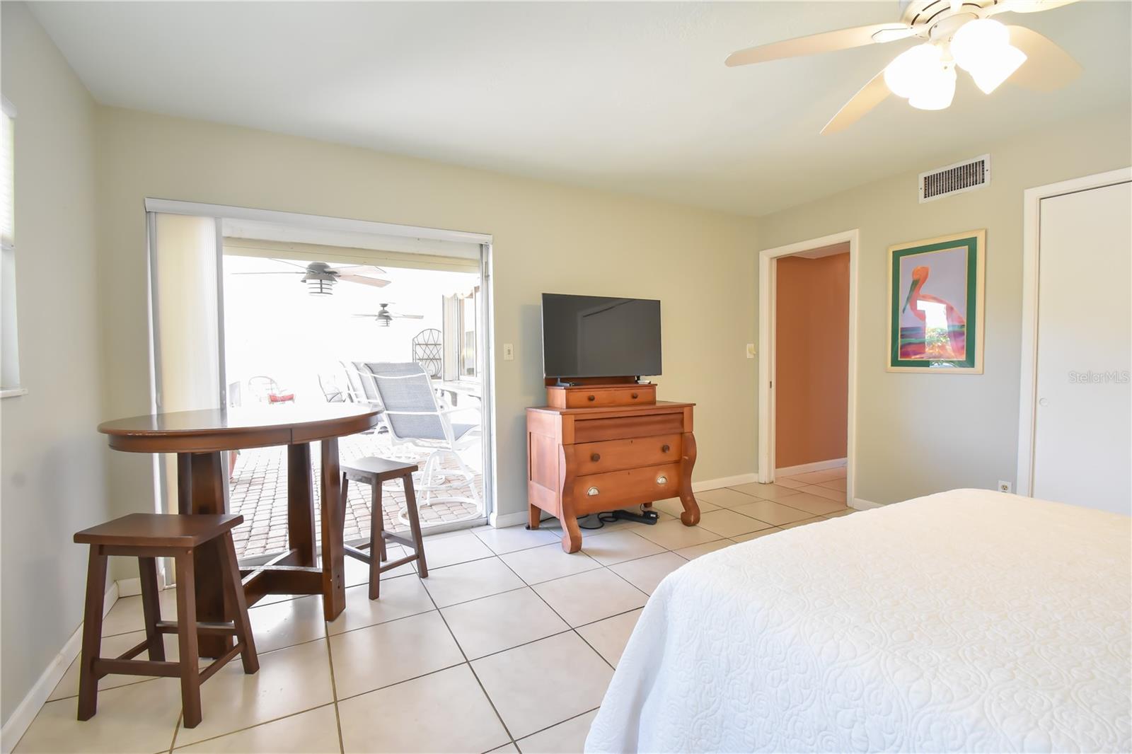 Guest bedroom shows sliding glass doors to pocrh