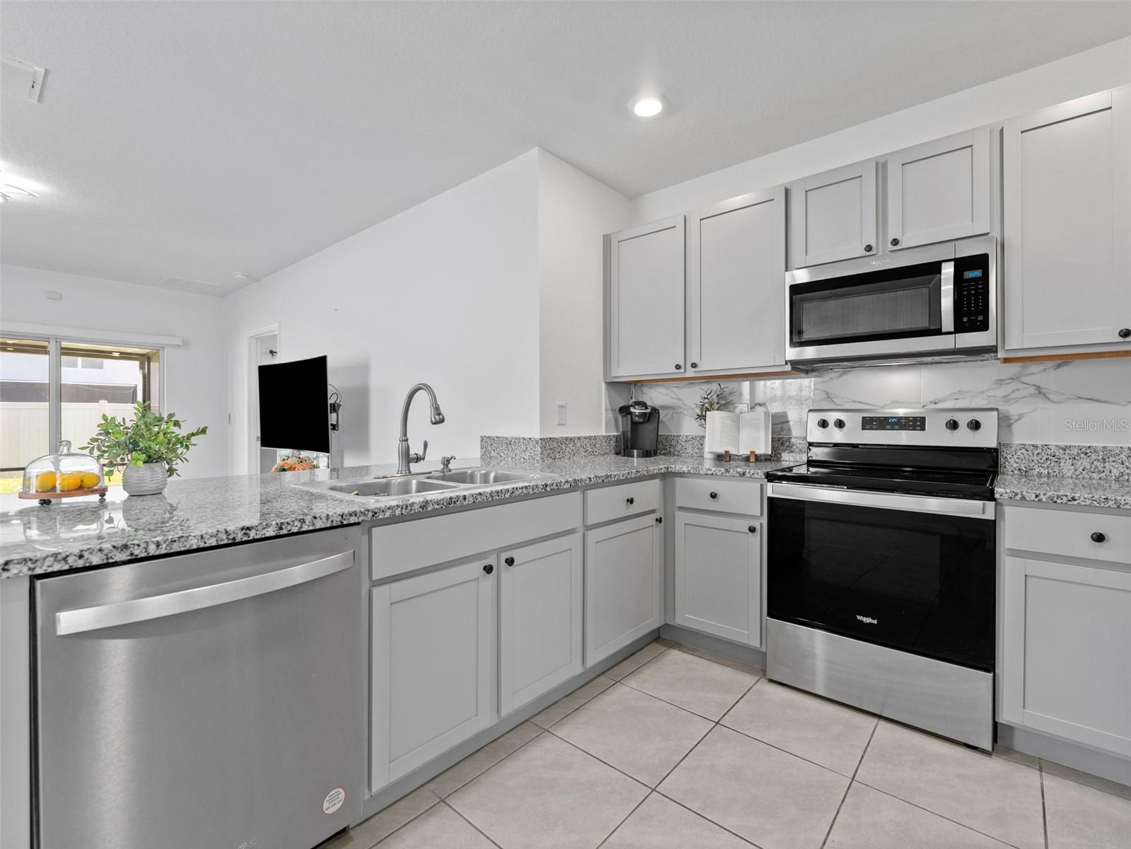 Well appointed kitchen opens to living room.