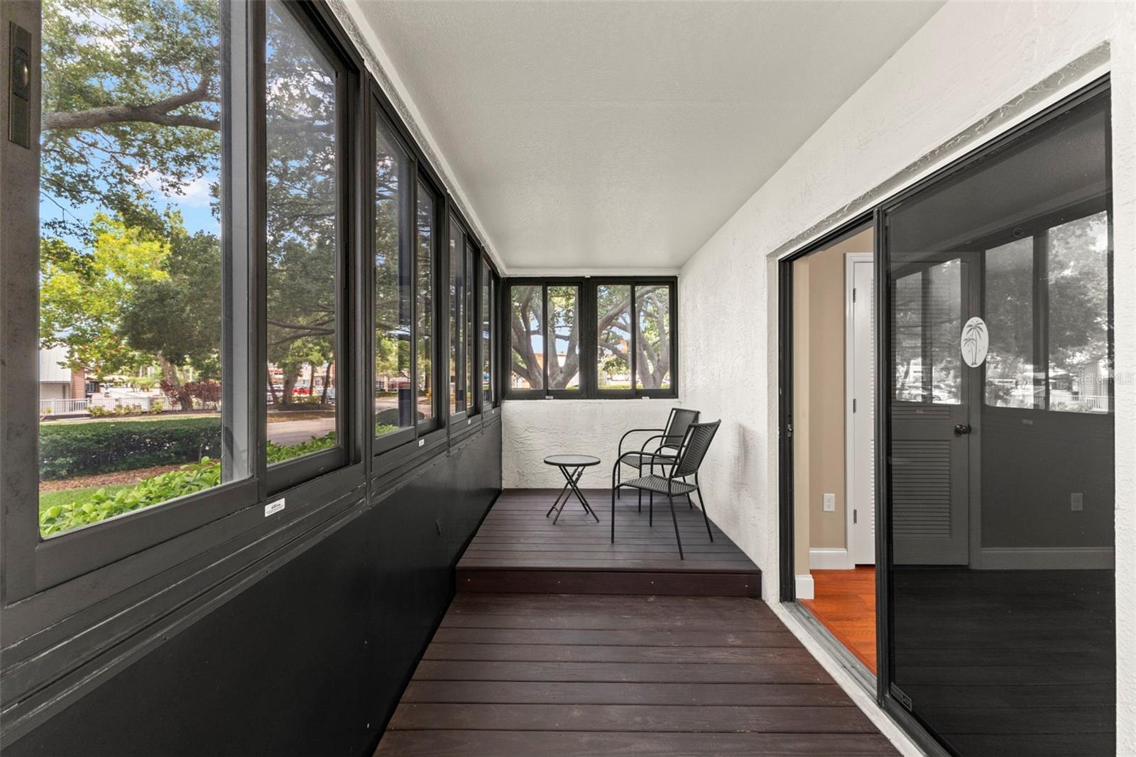 A private retreat with wall-to-wall windows, composite decking, and serene views of the beautifully maintained grounds.