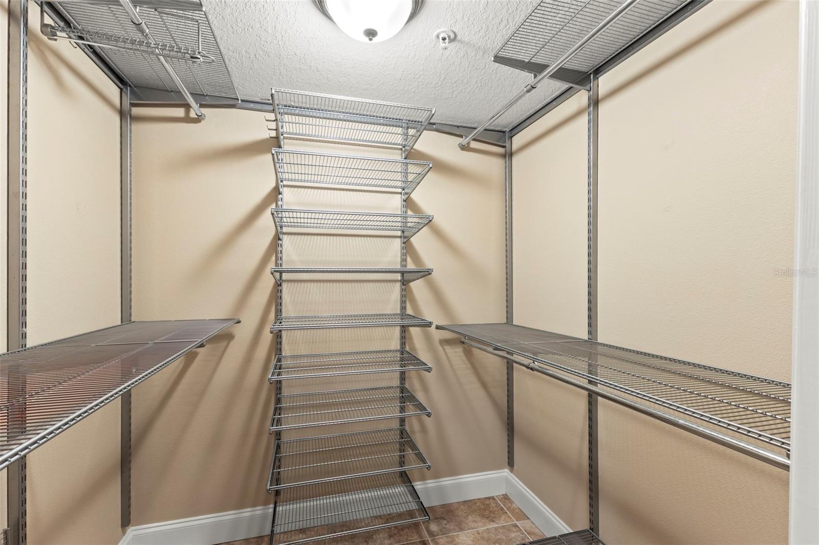 The walk-in closet features an organized shelving system with ample space for clothing, shoes, and accessories.