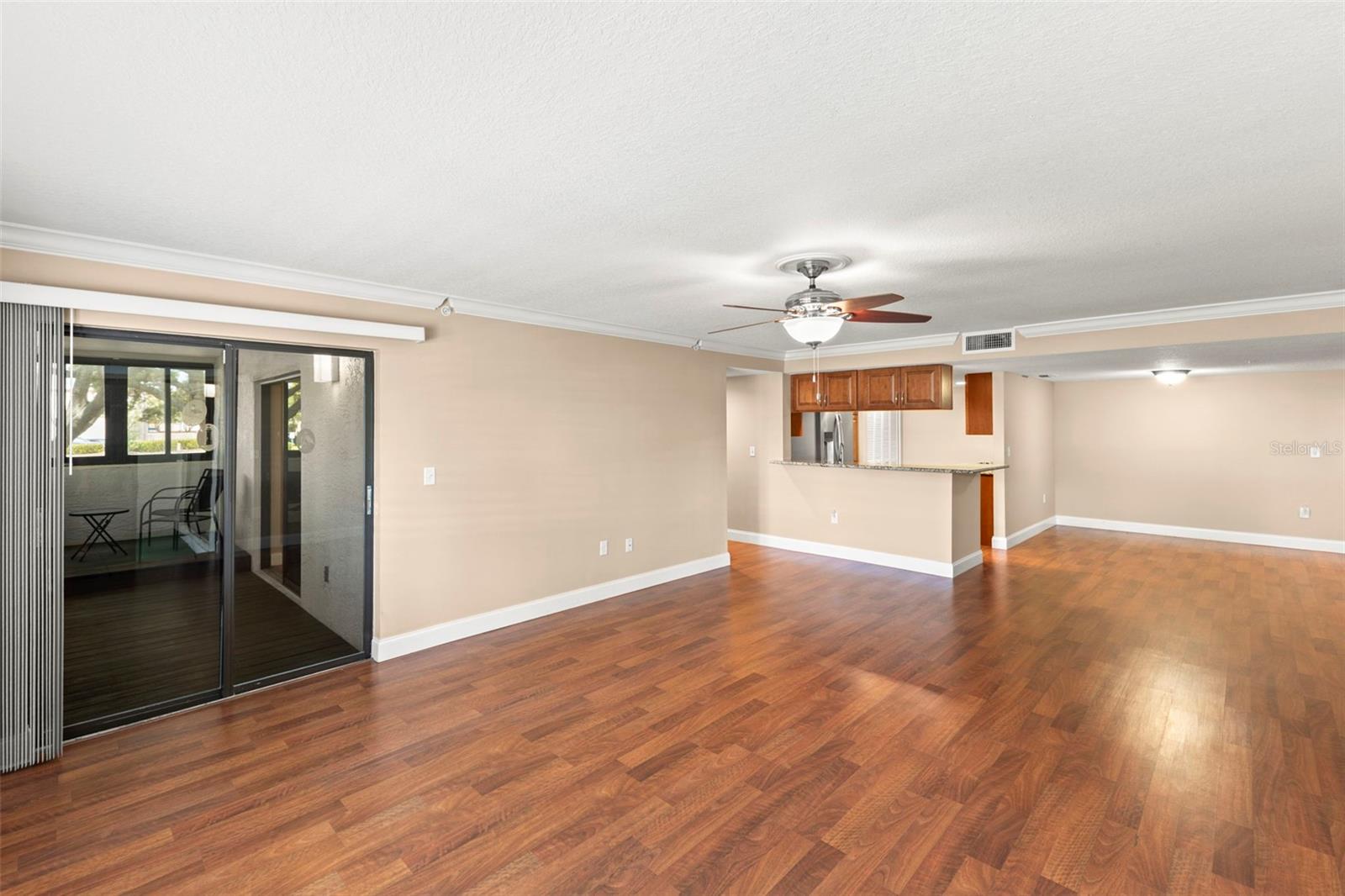 A neutral color palette, wood-look flooring, and an open-concept design create a bright and versatile living space.