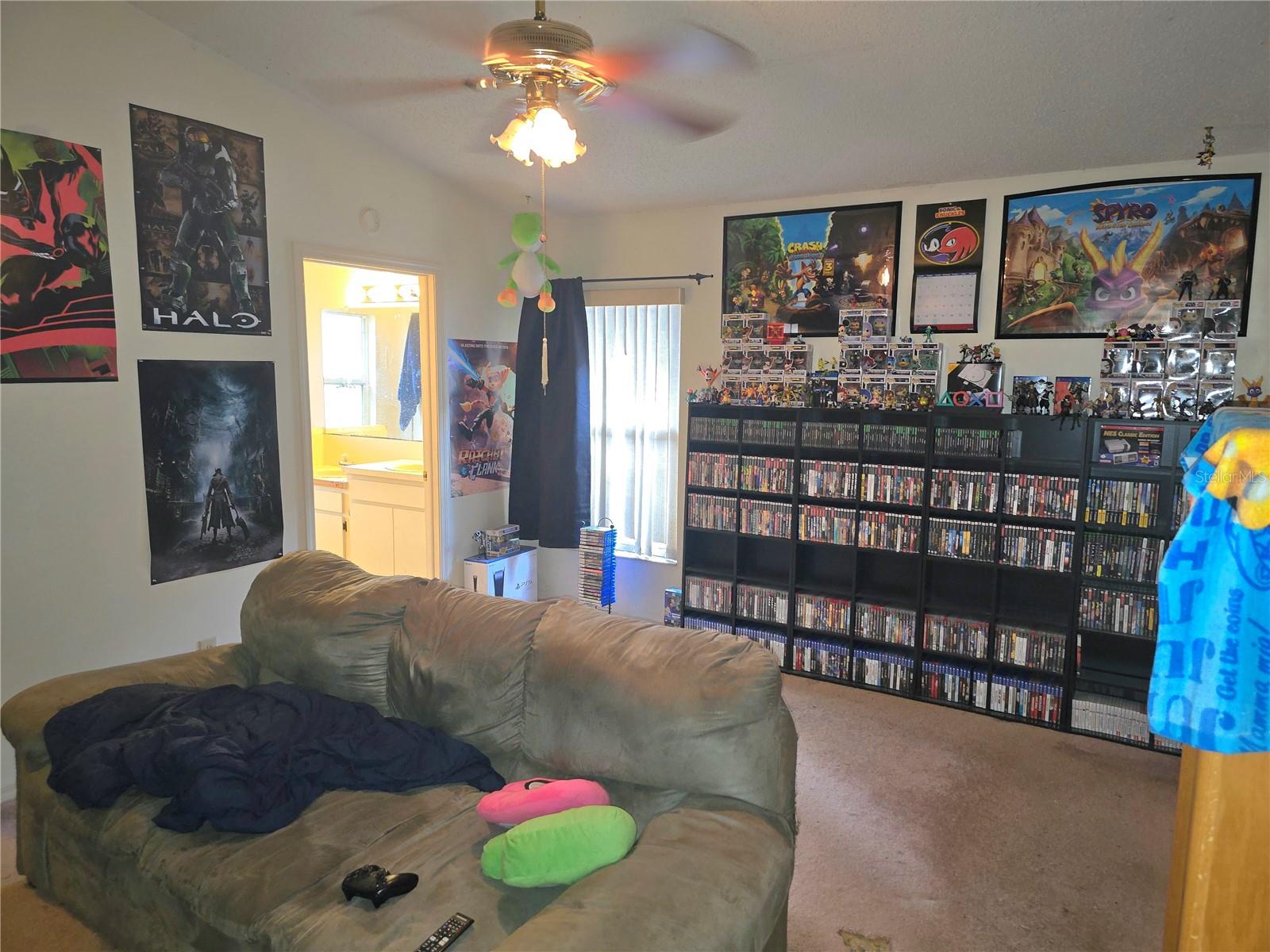 Primary bedroom currently used as a media room. with access to the bathroom