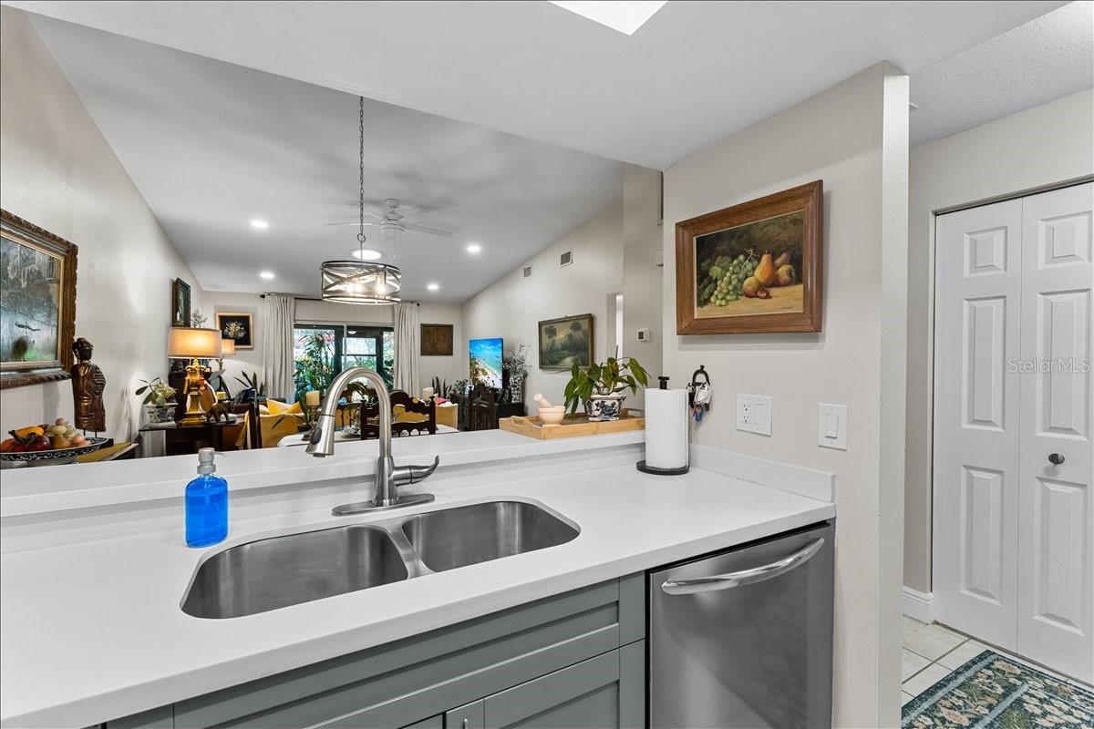 Kitchen features updated cabinetry, double sink, and Corian countertops