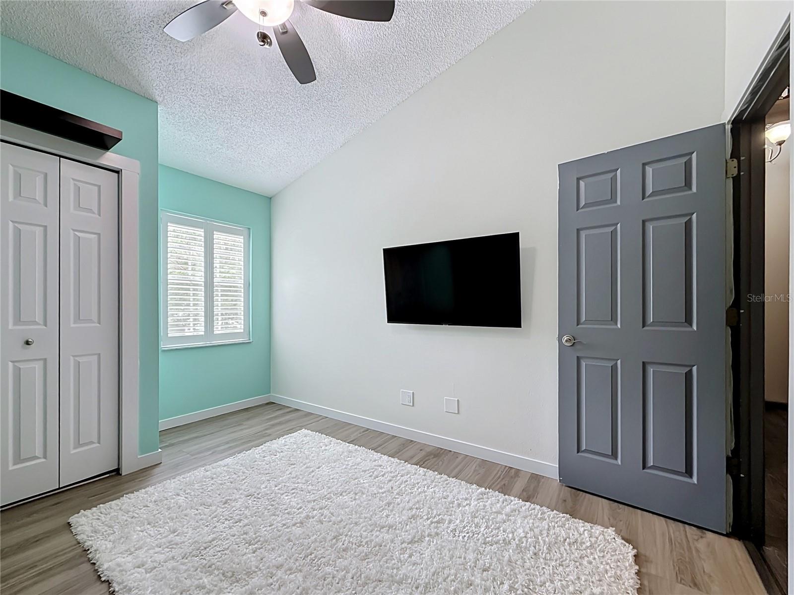 BR 2 has vaulted ceiling & plantation shutters