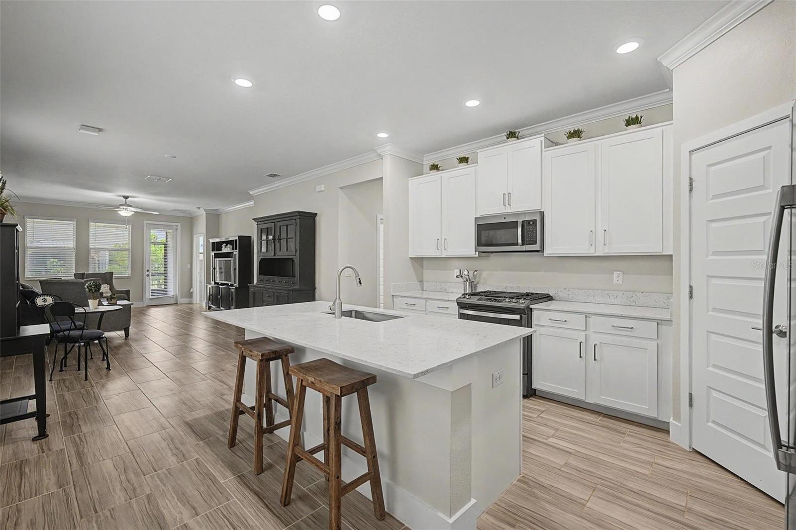 Bright kitchen with recessed lighting and breakfast bar