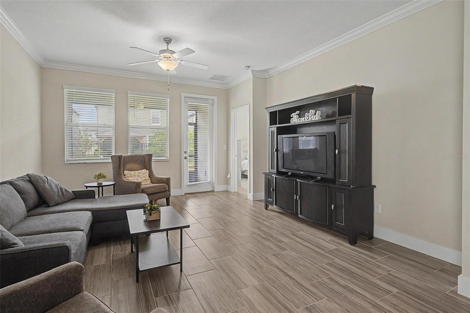 Family room with neutral color palette and direct access to patio