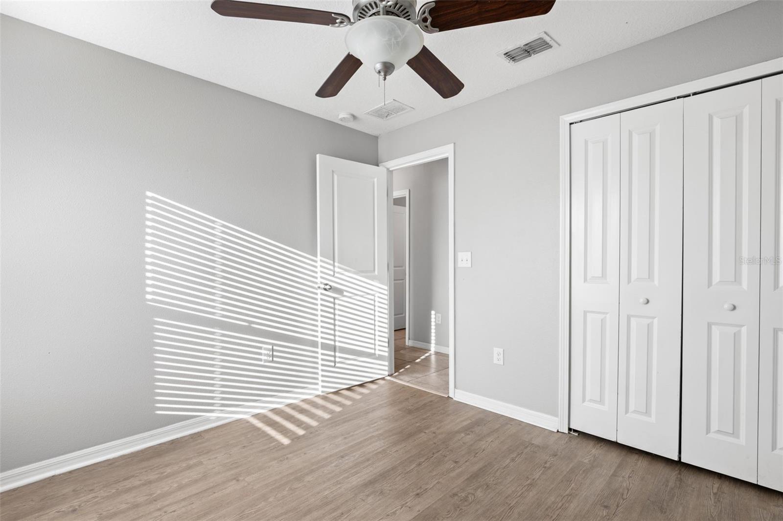 Primary bedroom highlights its generous proportions, natural light, and ample wall space for flexible furniture placement.