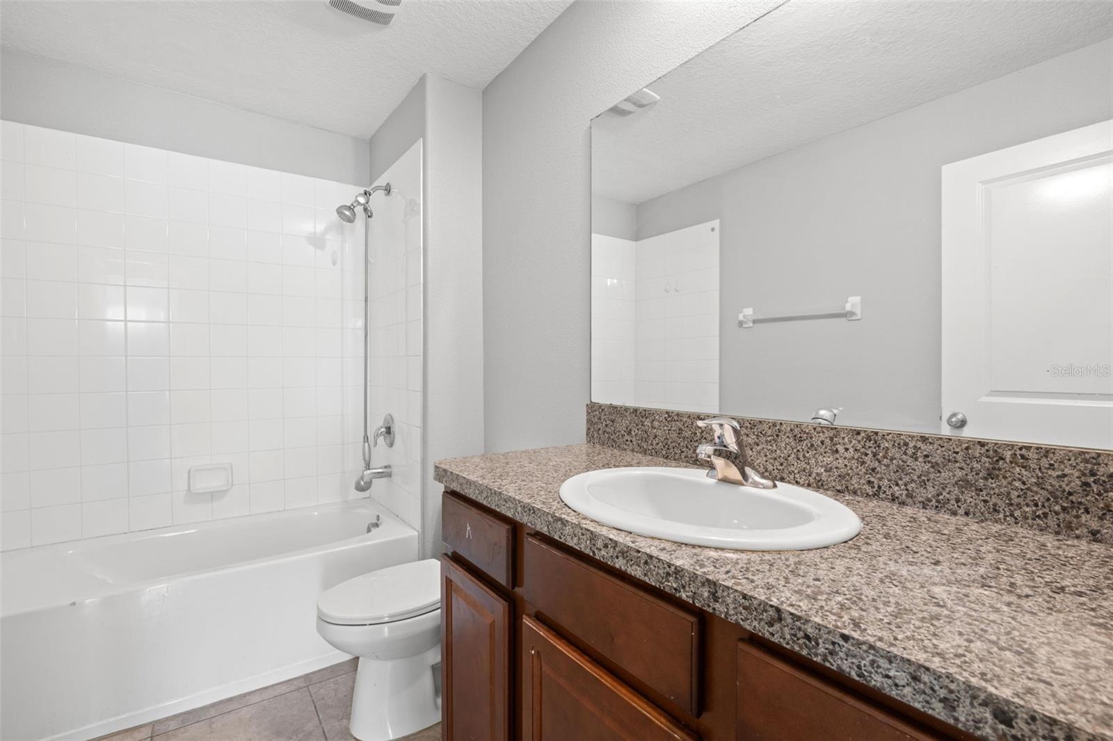 Dedicated laundry room with upper wire shelving for convenient storage and organization.