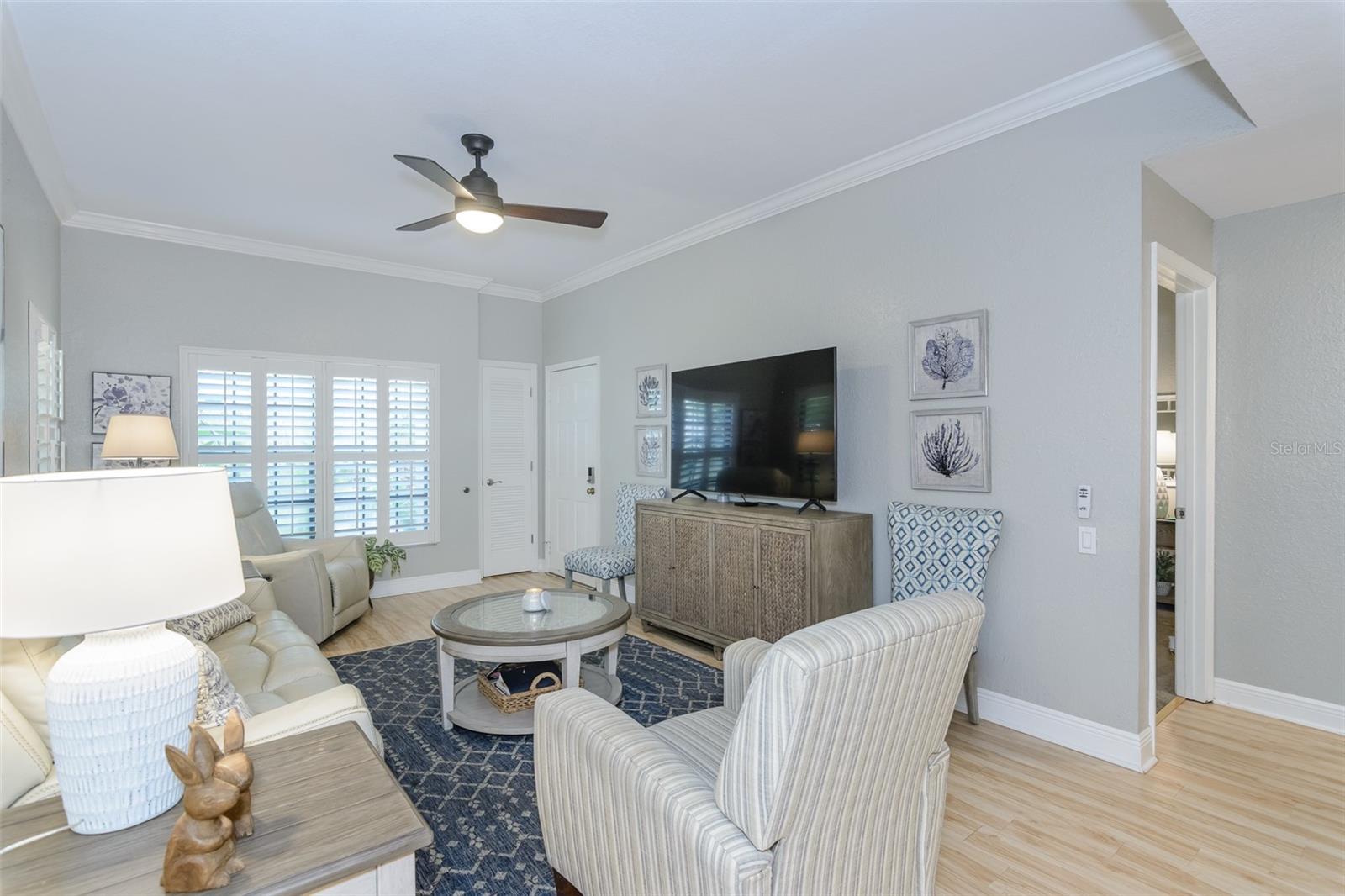 Bright and cheerful living room with newer plantation shutters.