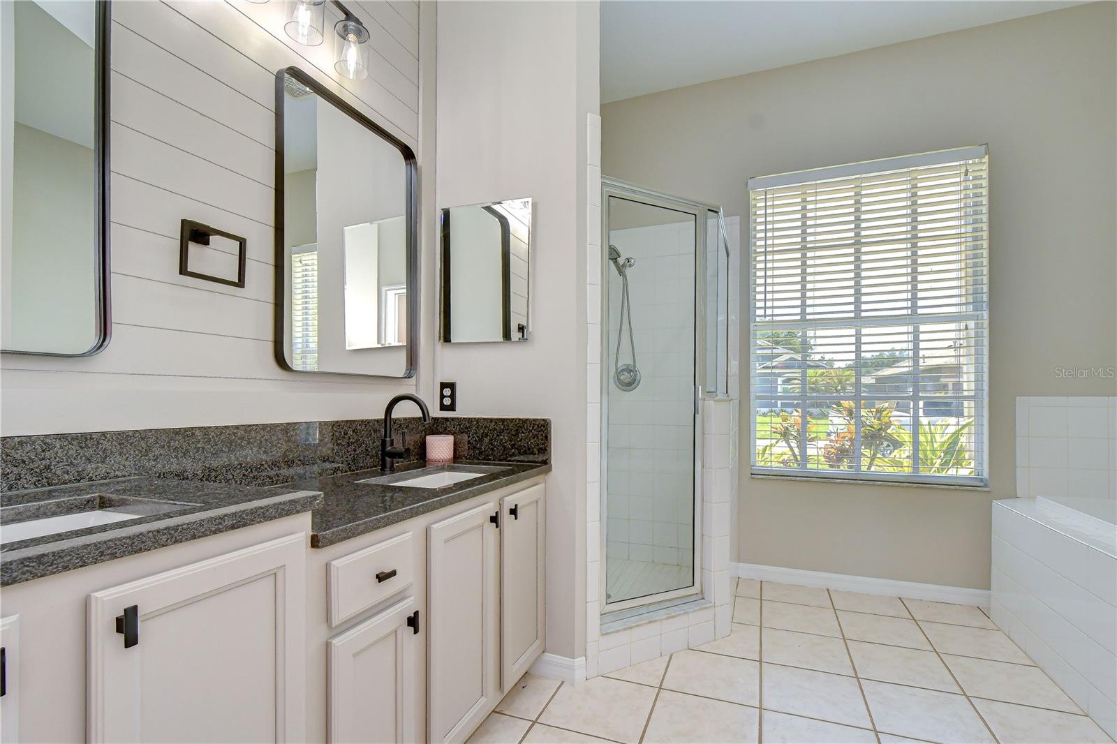 Private en-suite bath with dual closets and functional design.