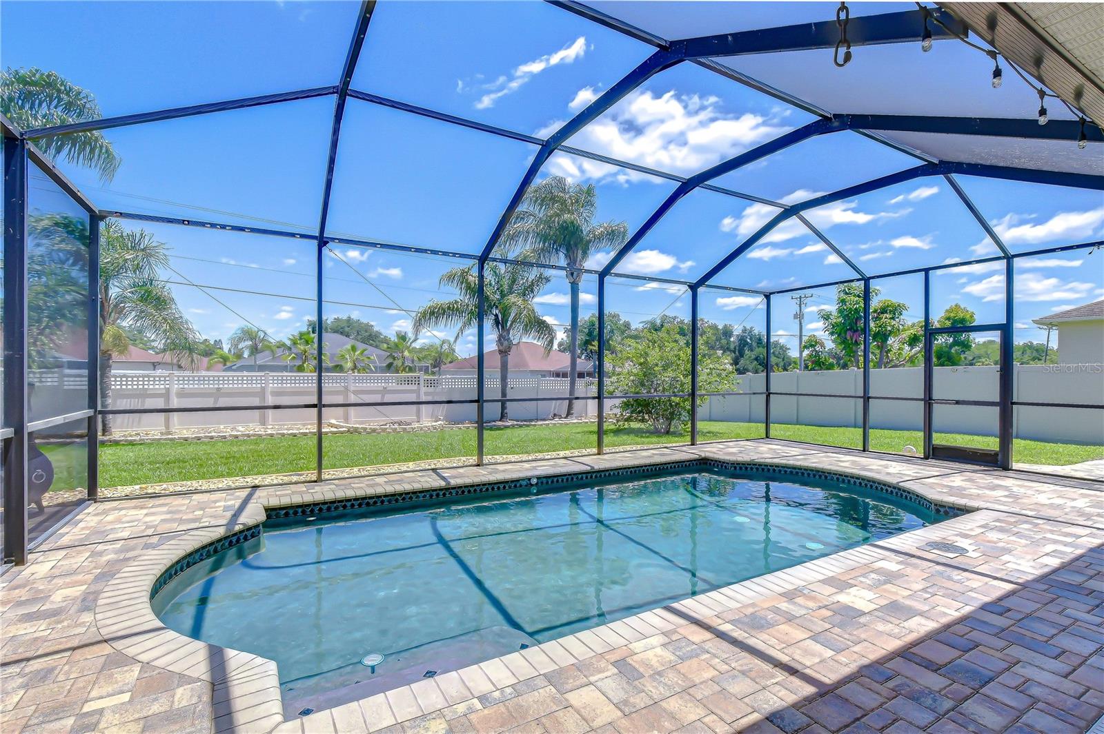 Sparkling pool surrounded by tropical landscaping.